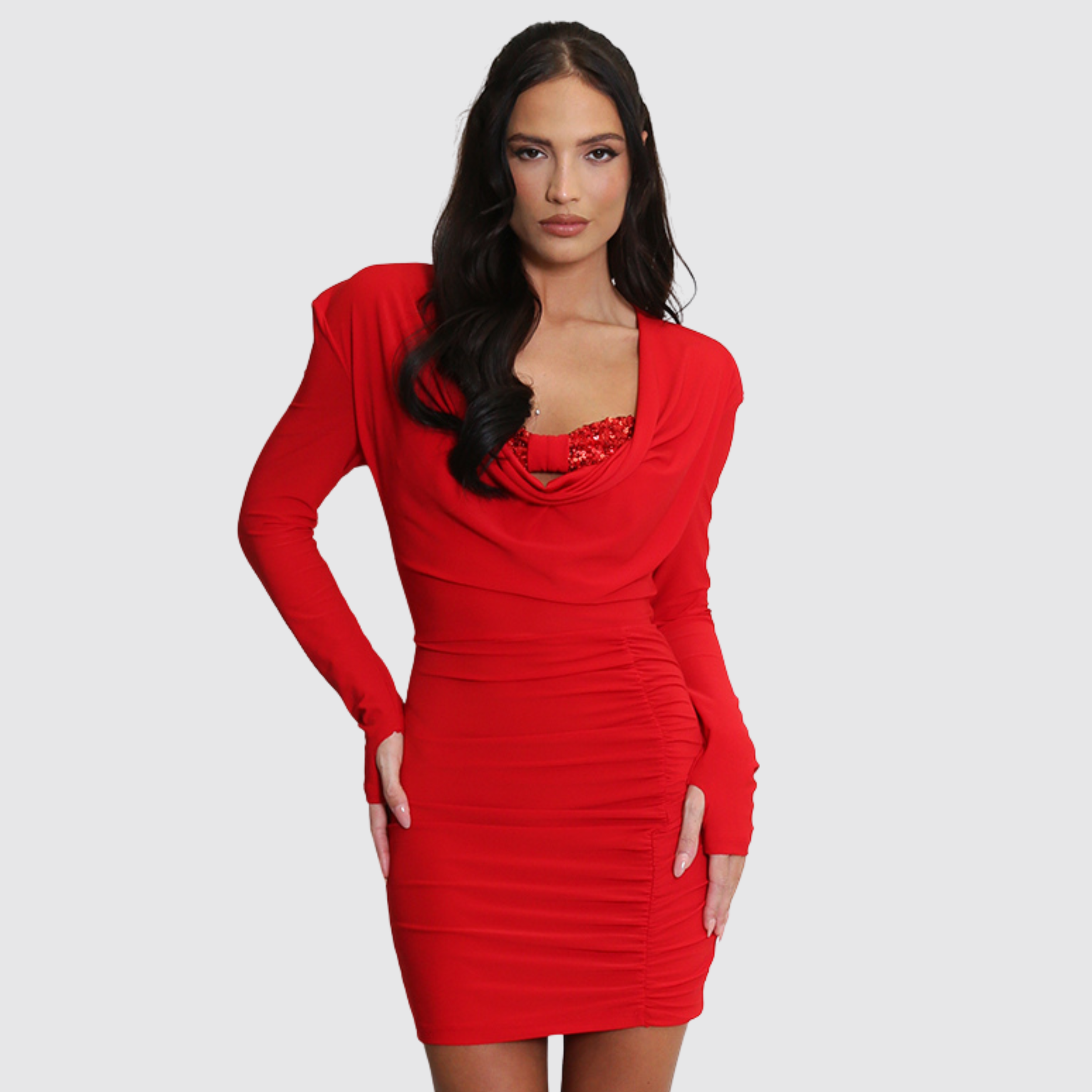 Female model wears a long sleeve bodycon dress with red sequin bralette.