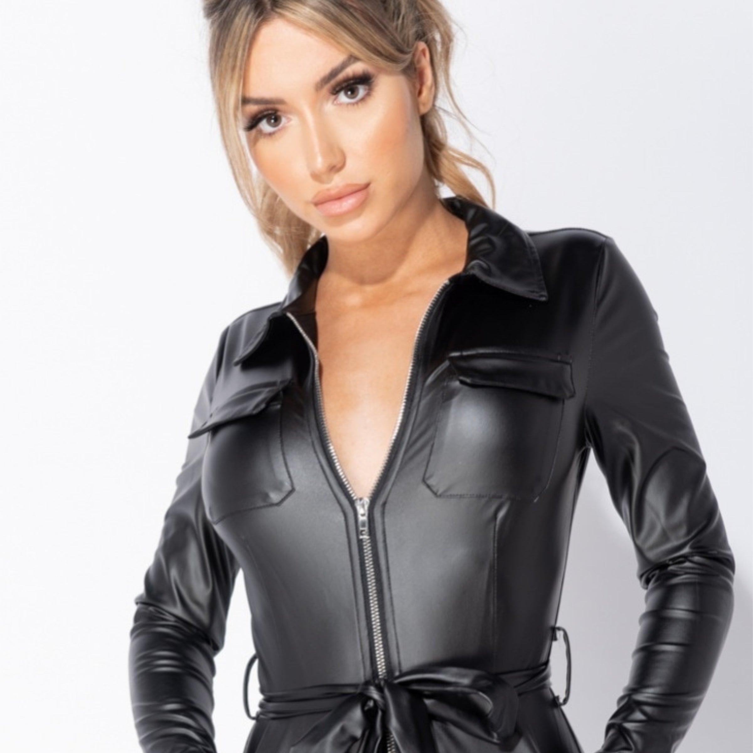 4ever Stunning Best Seller Collection Tile. Model wears a faux leather jumpsuit with front zip fastening.
