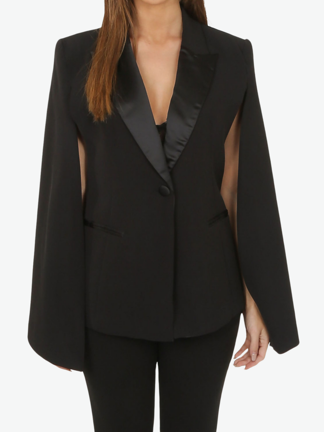 Model wears black cape blazer with side split and black satin lapel. The blazer has front button fastening.  Model has both her hands to the sides.