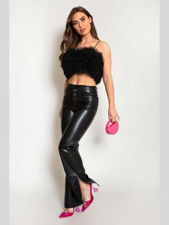 Full length. Model wears  a black organza ruffled crop top ,with spaghetti strap and zip back fastening. Model has tanned skin and long brown hair. Model wears the organza top, pu leather trousers and pink heeled shoes and mini bag.