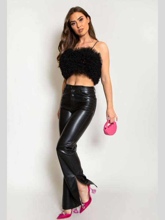 Full length. Model wears  a black organza ruffled crop top ,with spaghetti strap and zip back fastening. Model has tanned skin and long brown hair. Model wears the organza top, pu leather trousers and pink heeled shoes and mini bag.