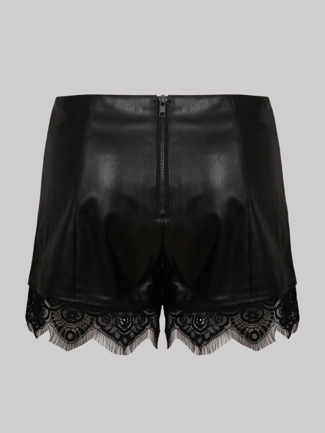 Ghost mannequin wears a  black faux leather shorts with panelled trim, a lace trim at the bottom of the shorts and an exposed zip back fastening. The ghost mannequin stands with her back to the camera, the back of the shorts can be seen, including the exposed zip fastening and the black lace trim at the bottom of the shorts.