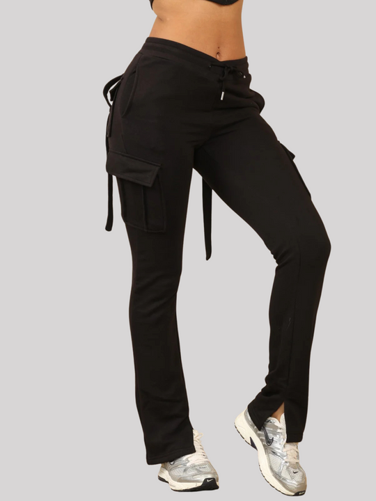 Model wears a Black Cropped Top Hoodie With Zip Front Fastening and Fitted Chargo Jogger Set. The cargo jogger has pockets and one pocket on the long sleeve hoodie. The bottom of the trousers can be seen, including the looped cargo strips.