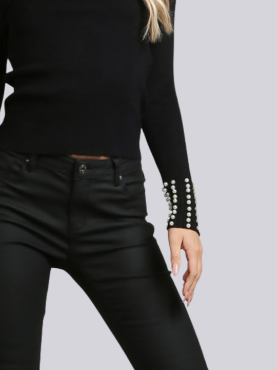 Close up of the black knitted jumper, with pearl detailed cuff sleeves.