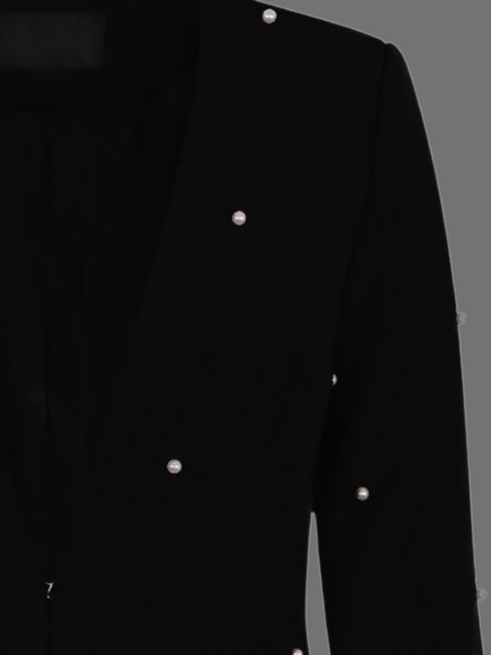 Ghost manequin wears a luxe black lapel-less blazer, with a tailored silhouette, front fastening and  decorative pearls accebrs  at the front of the blazer and blazer arms.  The picture shows a closeup of the ghost manequin, demonstrating a closer look at the pearl accents at the front and the sleeves.