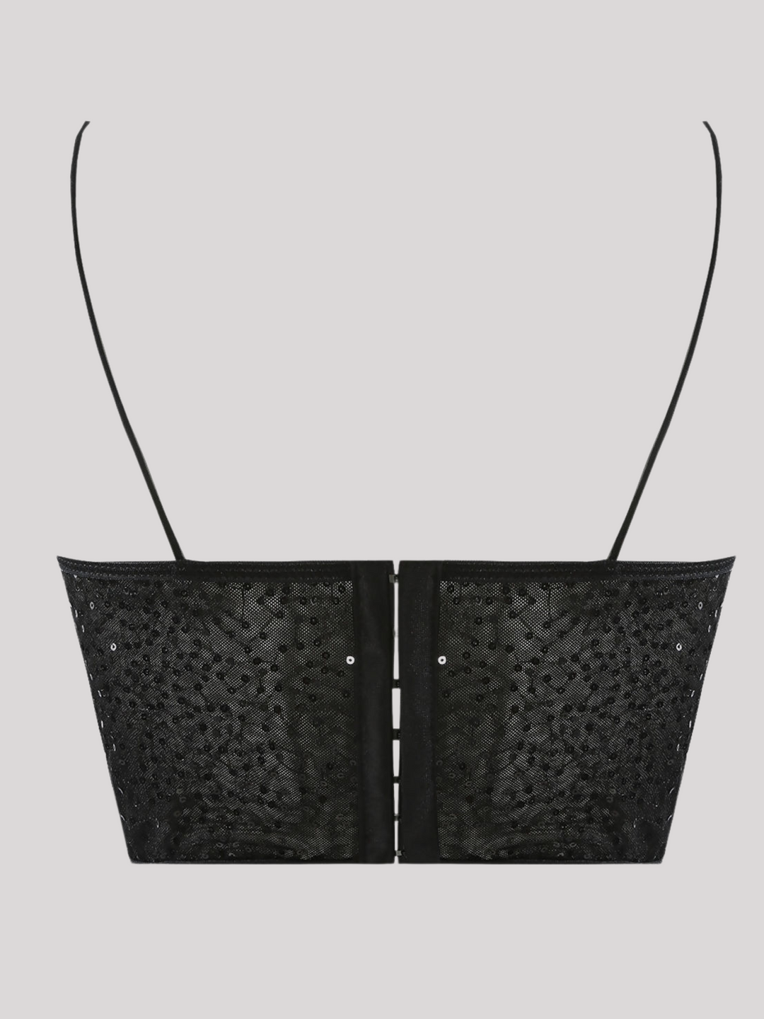 Ghost manequin wears a  black sequin crop top with hook back fastening and spaghetti straps. The crop top has a front sheer panel with sequin detailing. The ghost manequin stands with its back to the camera, the back of the top can be seen; including the hook zip back fastening.