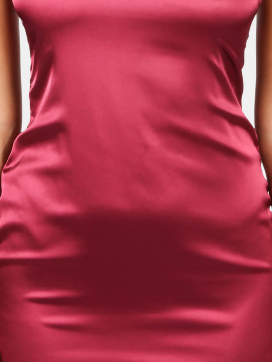 Closeup of the red satin mini dress. Model wears a red wine coloured satin mini dress with diamante straps and concealed zip back fastening.