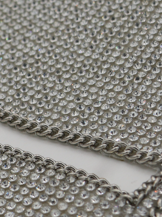 Close up of silver triangle diamante bralette with chain trim.  The two parting silver chains can be seen as well as the glistening shimmering diamantes.