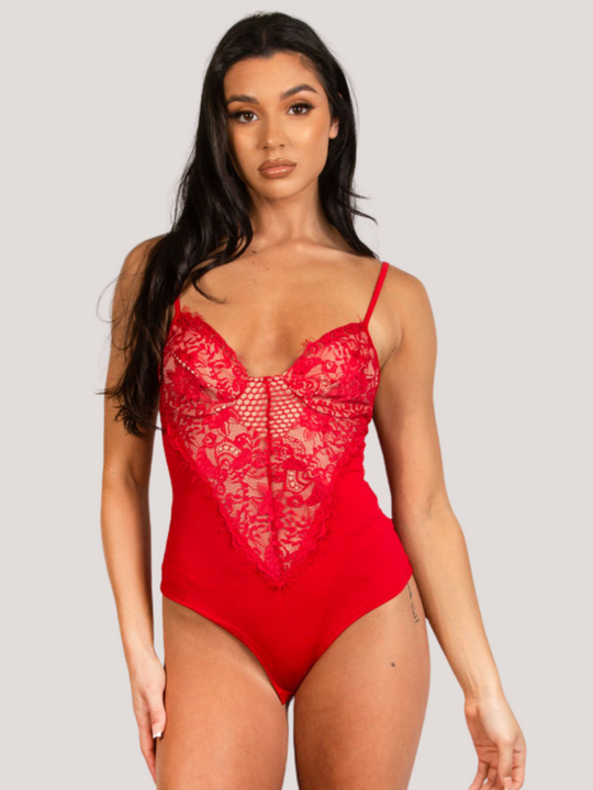 Model wears a red bodysuit with lace panel detailing. Model faces forward with both hands by her sides.