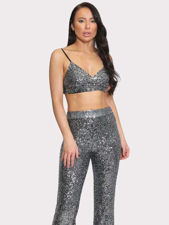 Model stands with her back to the camera, the back of the co-ord can be seen including the adjustable spaghetti straps.  Model has wavy brown hair and faces the camera.