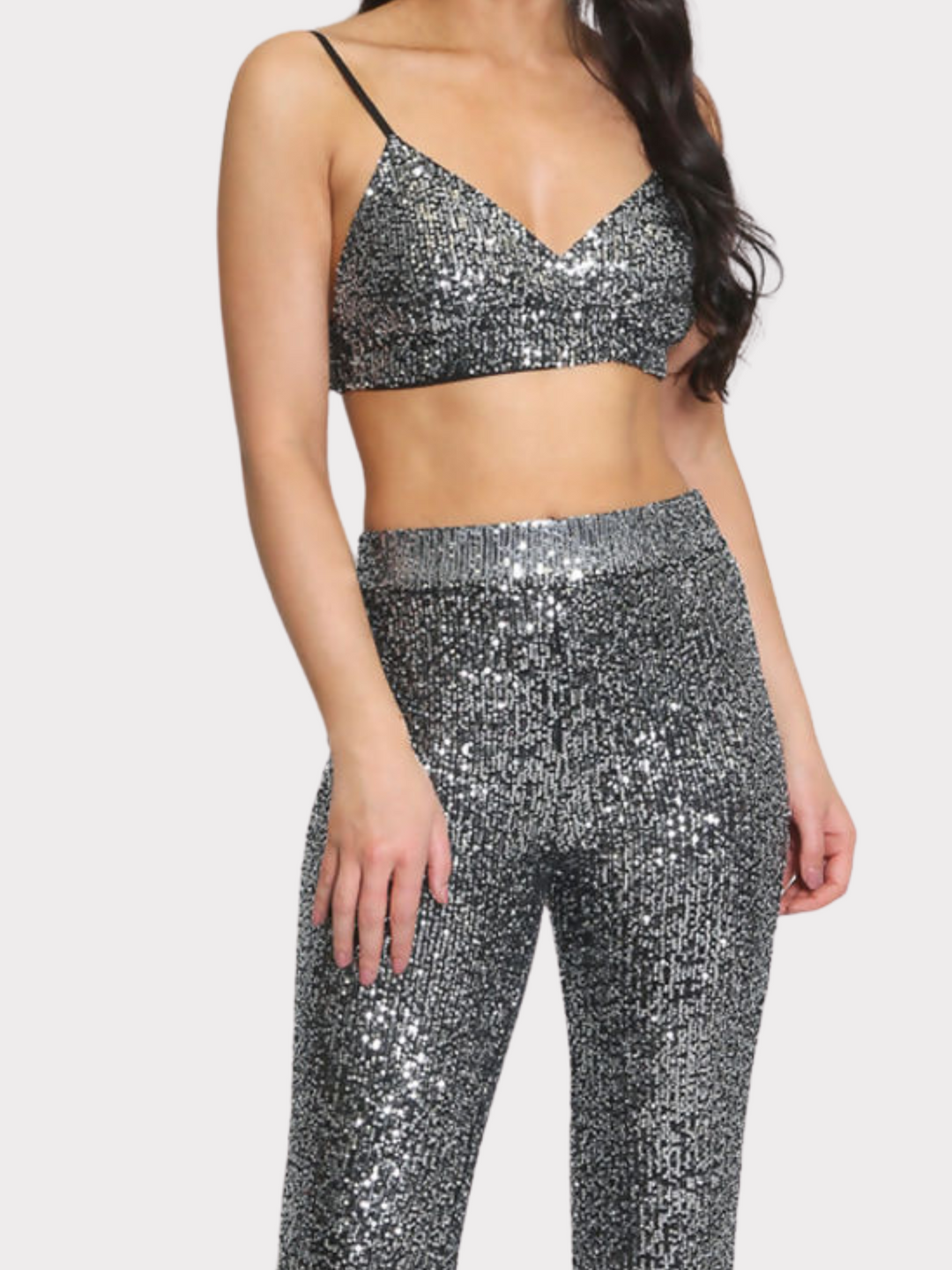 Mid length shot. Model stands with her back to the camera, the back of the co-ord can be seen including the adjustable spaghetti straps.