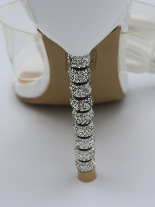 White strappy mules shoes with diamante stiletto heel. Close up of the diamante heel.