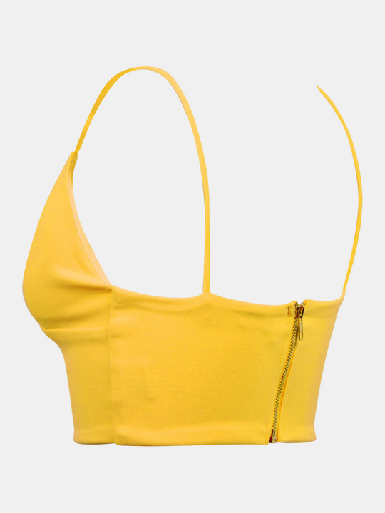 Ghost manequin wears a yellow bralete and v neck  front and spaghetti straps. Ghost manequin stands to the side, the back and side of thee bralette can be seen, including the zip up back.