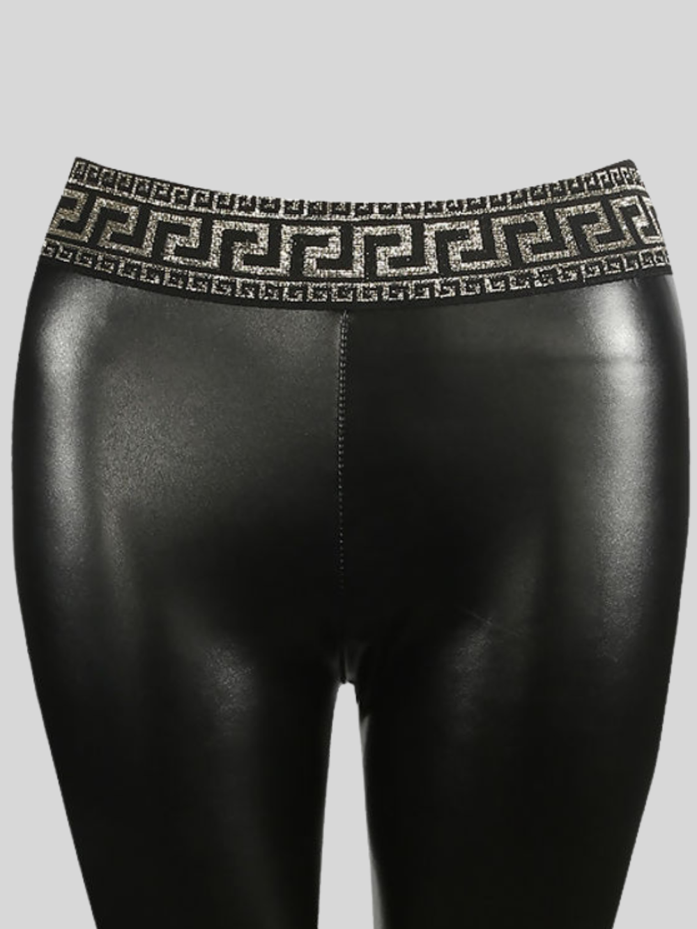 Close up. Ghost mannequin wears a black faux leather leggings with a fret waist band design. Te fret waist band can be seen.