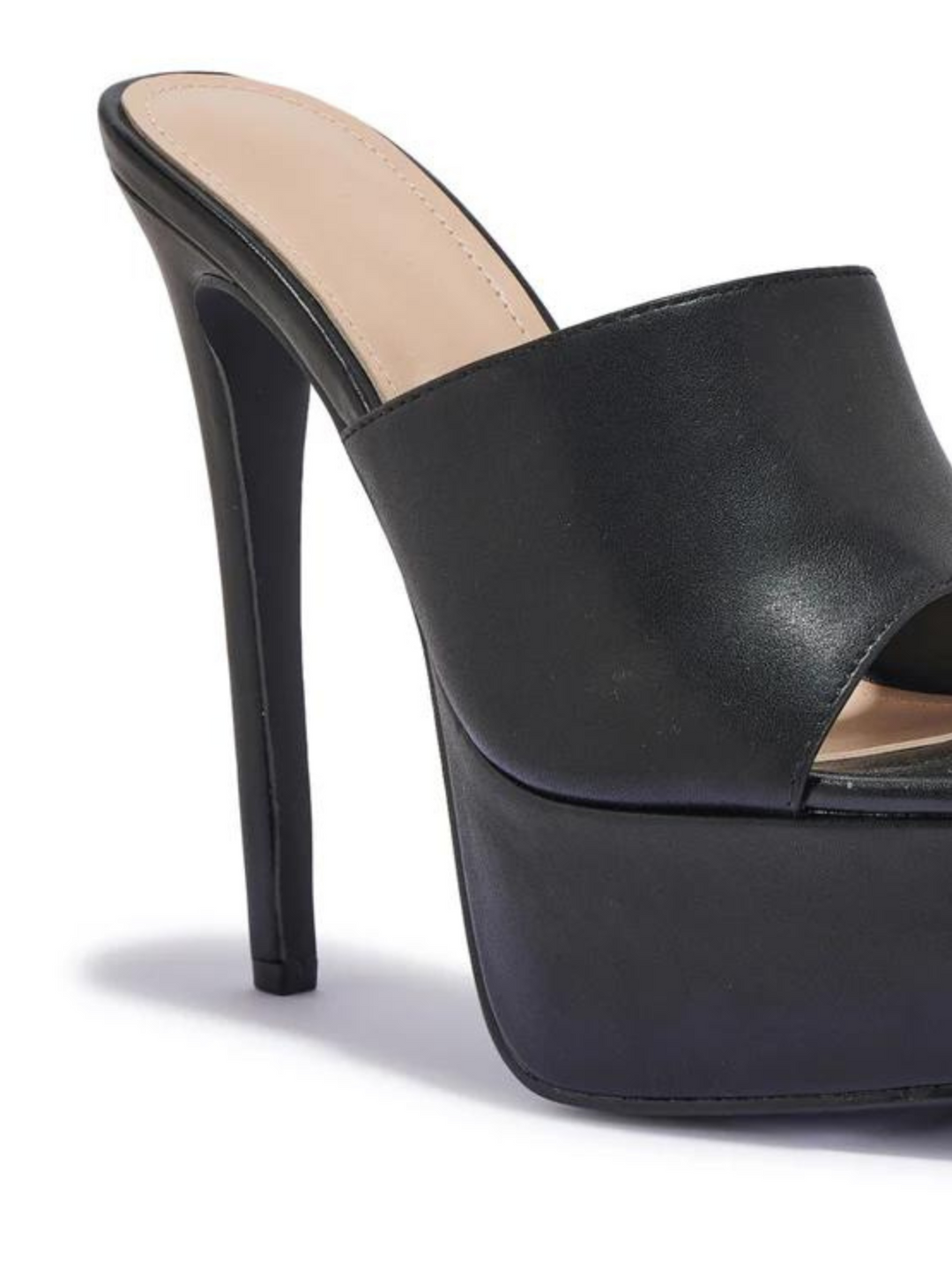 Black heeled mules that have a thick platform base and stiletto shoes. The picture shows a close up of the side of the black platform, showing the thick platform base.