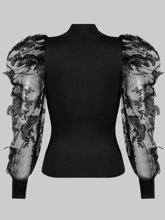 Ghost mannequin wears a black high neck jumper, with sheer sleeves and an embroidery crocheted design.  The ghost mannequin  stands with its back to the camera, the high neck of the jumper can be seen, as well as the sheer embrodied sleeves can be seen.