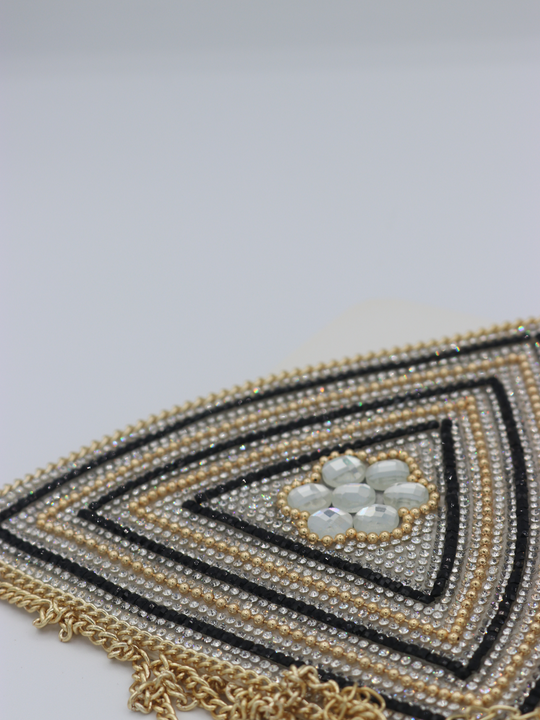 Close up of centre of the jeweled diamante bralette. The close up demonstrates the diamante and rhinestone design.  The gold chain fastening can be seen.