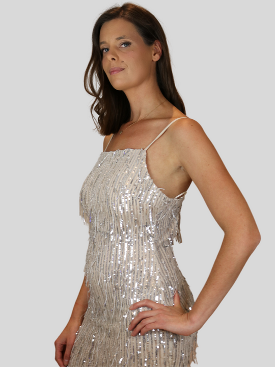 Model wears 4ever Stunning sequinned tassle dress with low back. Model stands to the side and places her hand on her hip.