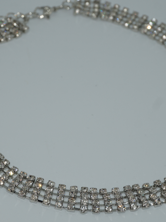 Close up of the silver diamante choker with interconnected links.
