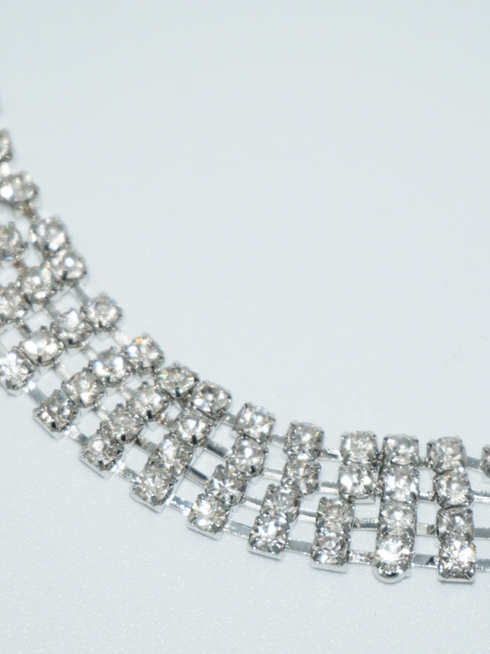 Close up of a silver diamante choker, the links are visible.