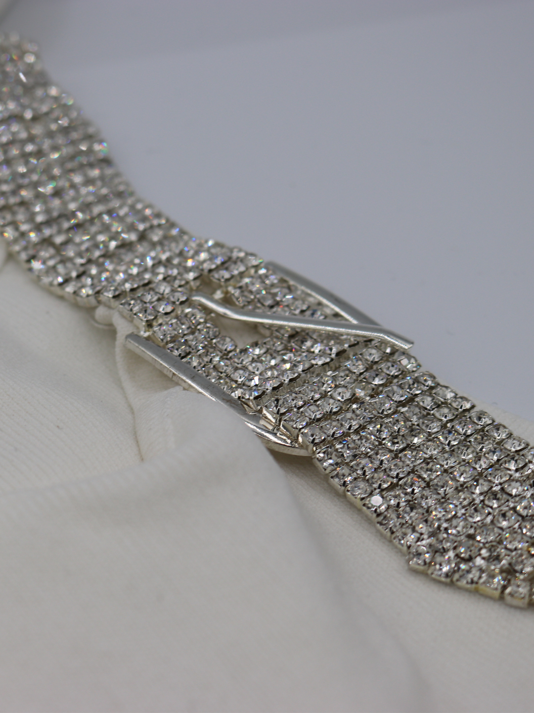 Closeup photograph of the diamante strap on the ribbed  cream mini dress.