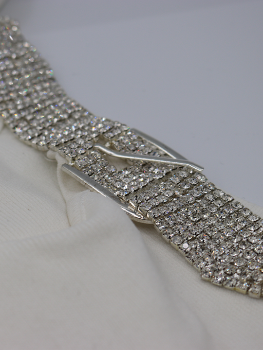 Closeup photograph of the diamante strap on the ribbed  cream mini dress.