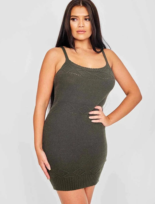 Model wear a green crochet dress. Model stands slightly to the side with one hand om her him and the other at her side. Model looks slightly to the side.