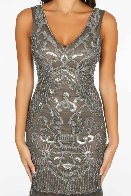 Sequined grey maxi dress with sequined straps. Model has  both arms to the side.