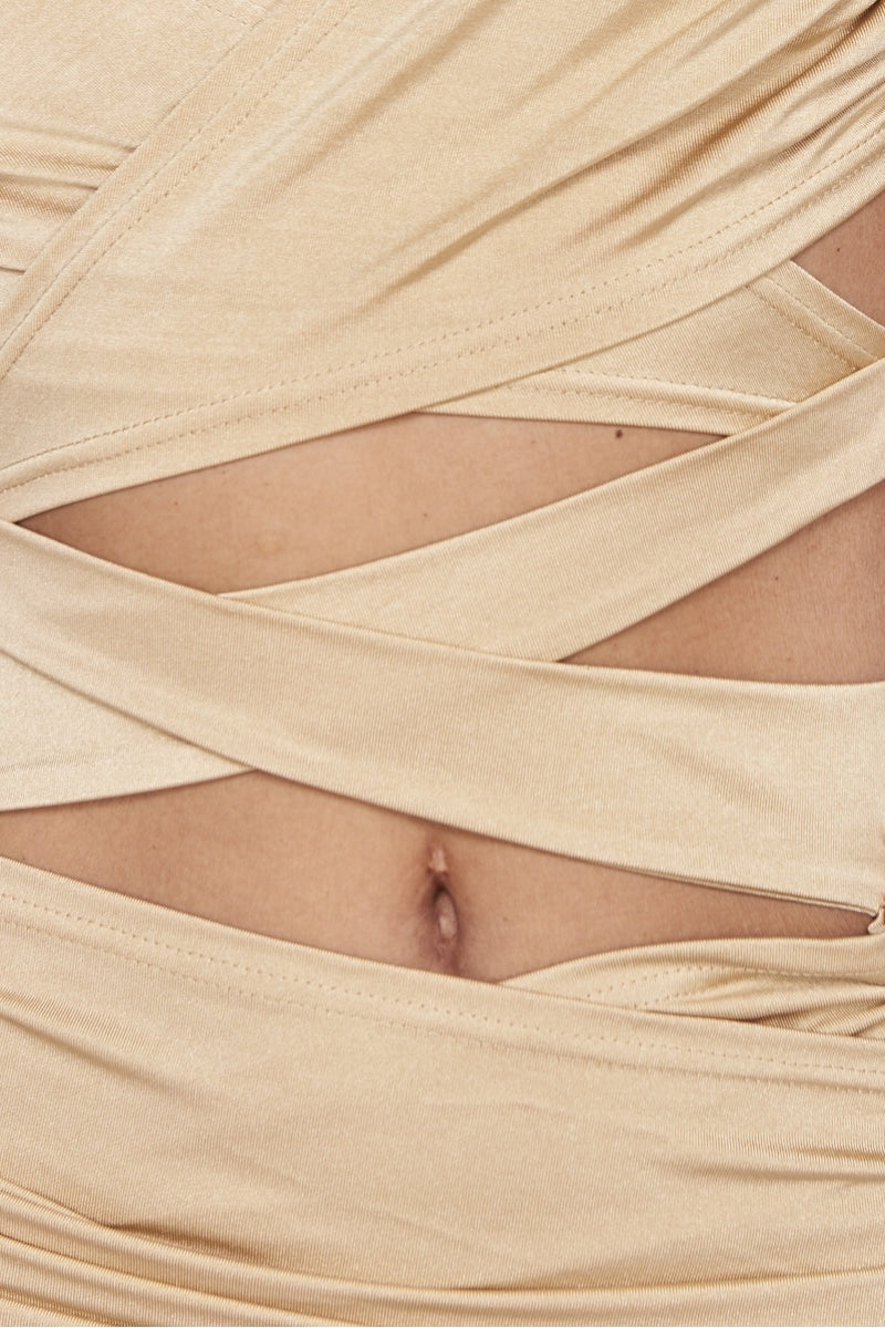 Beige bodycon mini dress with multiway cut out dress with halter neck straps. This is a perfect party dress that is a very sexy dress. Close up of the material.