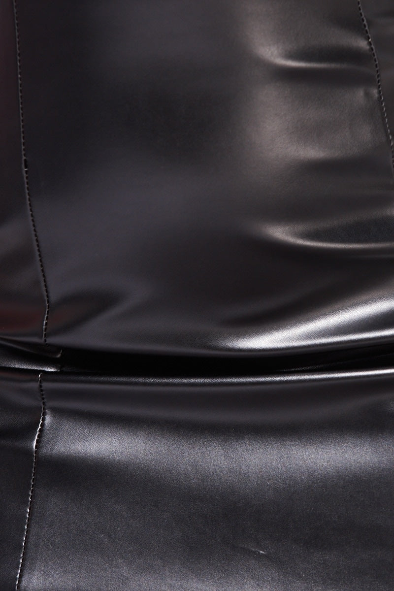 Close up of faux leather bandeau mini dress demonstrating the material.