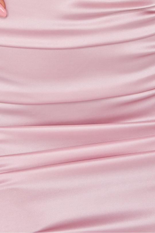 close up of pink ruched satin material.