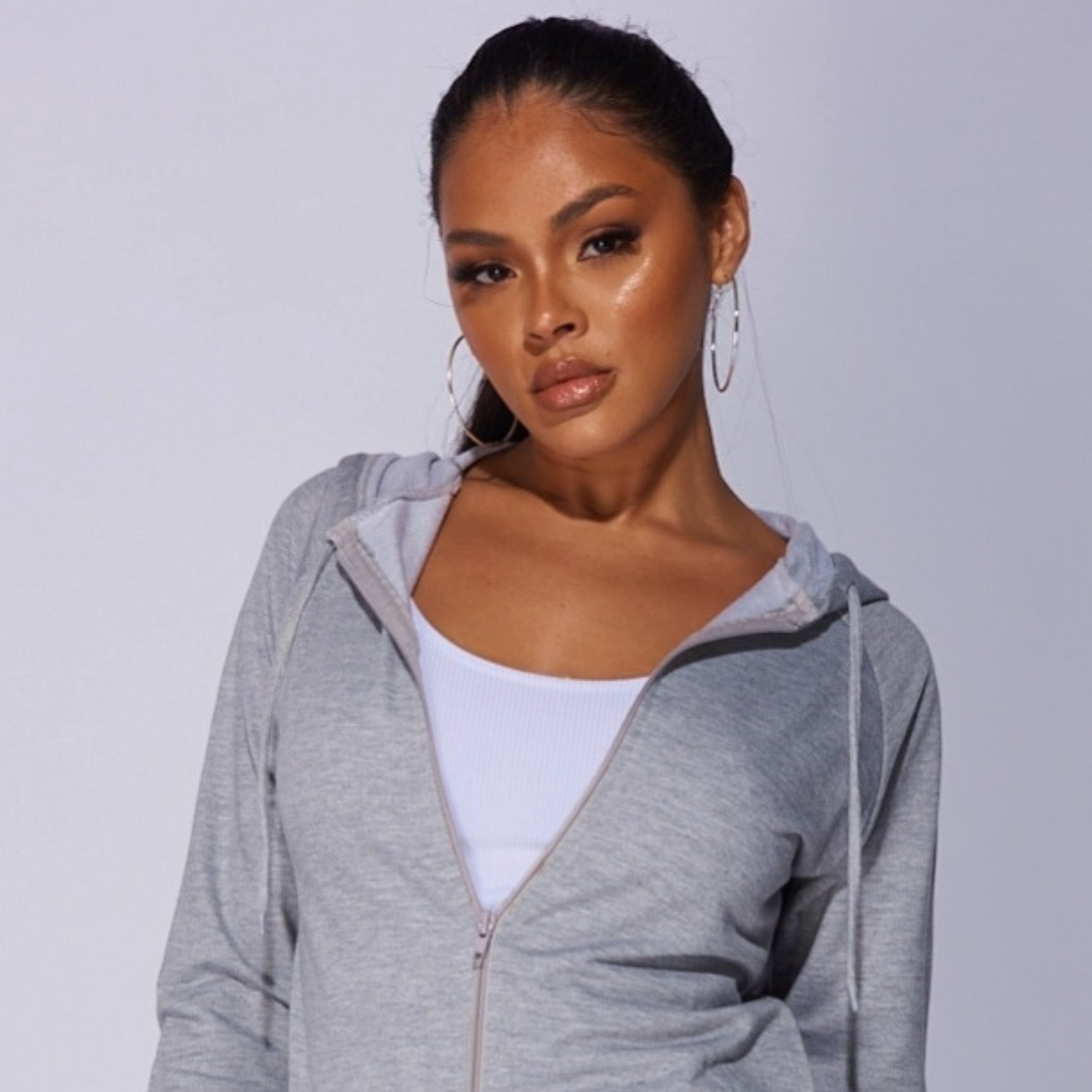 4ever Stunning Lounge Wear and Causual Wear Collection Tile. Model wears a grey tracksuit with front zip fastening. 