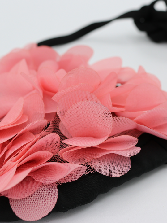 Close up of black bikini triangle top with chiffon 3d petals .This statement bikini set has an unusual pink 3d petal design and tie fastening bikini top strap with matching brief. 