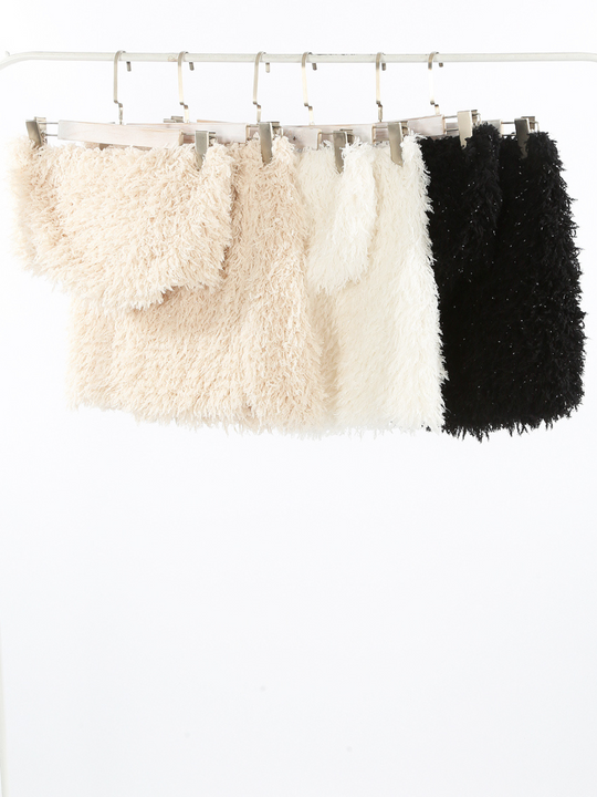 The different coloured co-ordinated sets can be seen on a clothing rail. The beige, white and black set can be seen.
