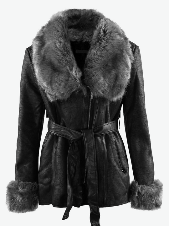 Ghost manequin wears a faux leather longline jacket with faux fur grey  collar and faux fur grey cuffs. The jacket has a tie front  belt that is tied at the waist. 