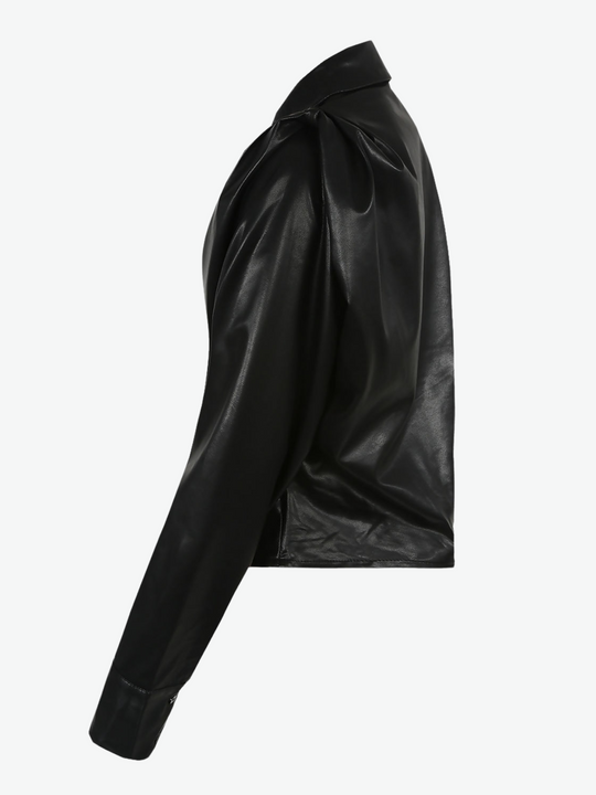 Ghost manequin wears black faux leather shirt with  pleated shoulders and long sleeve. The pu cropped front button shirt  and collard neck.  Ghost manequin stands to the sidem the side of the shirt is visible. 