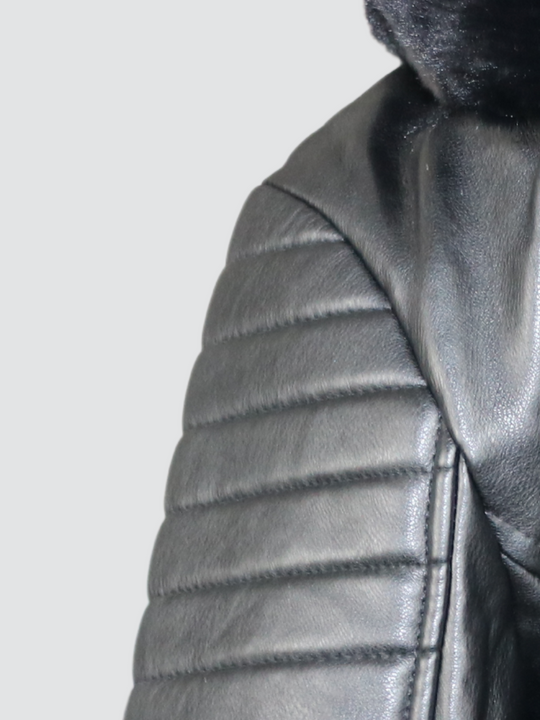 Close up of the shoulder panelled detailing of the faux leather biker jacket with faux fur trim.