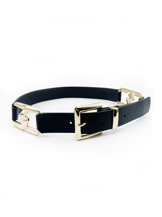 Black faux leather belt, with gold chain detailing and front gold buckle fastening. The belt has an adjustable waist ban and is placed on a plain cream background. 