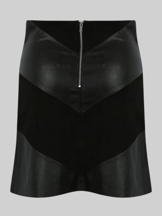 Ghost mannequin wears a black pu fau leather mini skirt, with faxu suede panels. The ghost mannequin stands in front of a plain bakground and stands with his back to the camera, the back of the skirt can be seen, including the faux suede and faux leather panels. The exposed zip back fastening is visible. 