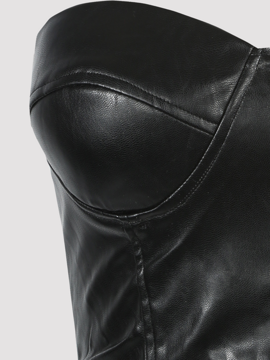 Close up. Ghost manequin wears black faux leather bralette crop top, with sweet heart neckline. The close up of a bralette cup can be seen. 