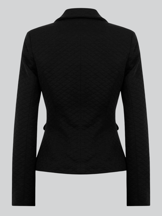 Ghost mannequin wears a black quilted blazer with gold buttons and front pocket design. The ghost mannequin has its back to the camera, the back of the blazer can be seen, including the tailored style design. 