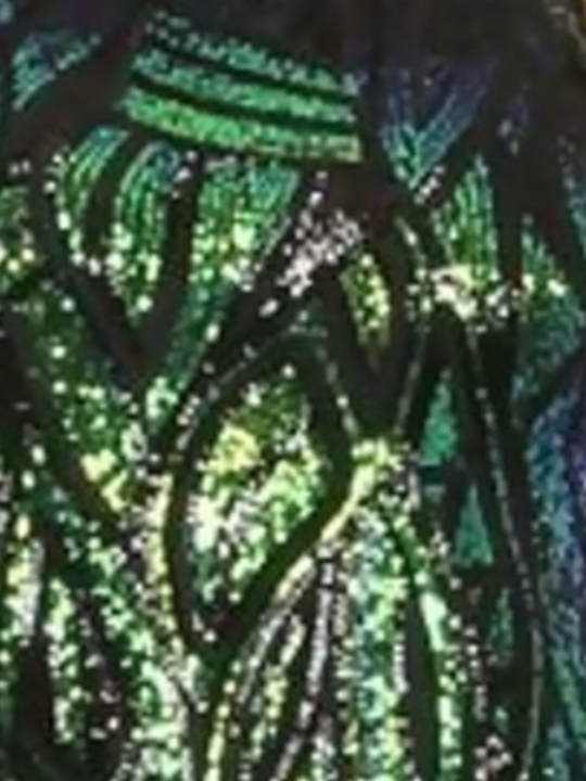 closeup of Model wears long sleeved green and black sequined midi dress with open back. 