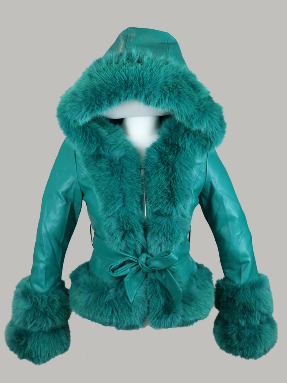 Ghost manequin wears a green faux leather jacket with green faux fur trim. The  green jacket has a faux fur hooded trim and large faux cuffs at the sleeves and a faux leather belt. The ghost manequin wears the hood and the removable faux leather belt. 