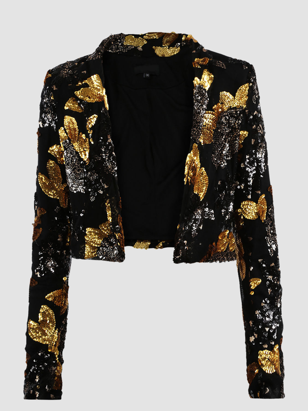 Ghost mannequin stands in front of a plain background. The ghost mennequin wears a black and gold sequinned cropped blazer with open front and long sleeves.The black and gold sequinned blazer has an open front and a luxe design. The ghost mannequin faces forward and the front of the blazer can be seen, including the open front. 