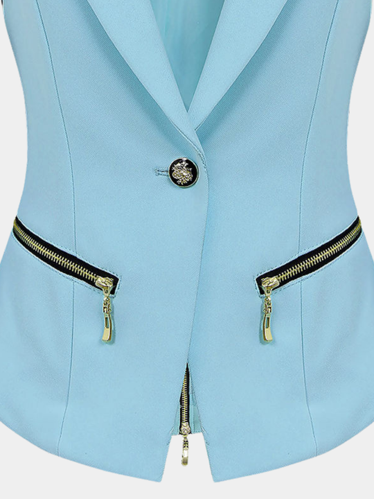 Close up. Ghost mannequin stands in front of a plain background wearing a light blue blazer. The close up shows the single black and gold butten and the exposee zip design at the side of the light blue blazer.