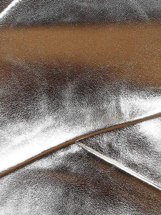 Close up of gold metallic top, including the cross over strap and shiny gold metallic coverings.