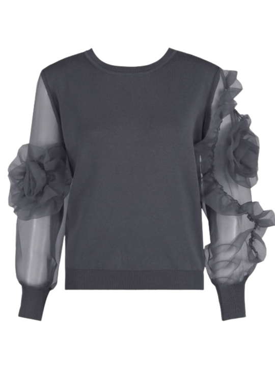 Ghost mannequin stands in front of a plain background and wears a grey crew neck jumper, with mesh sheered sleeves with a ruffled  bsleeves balloon design. The ghost mannequin faces forward, the front of the luxe jumper can be seen, including the statement ruffled sleeves.