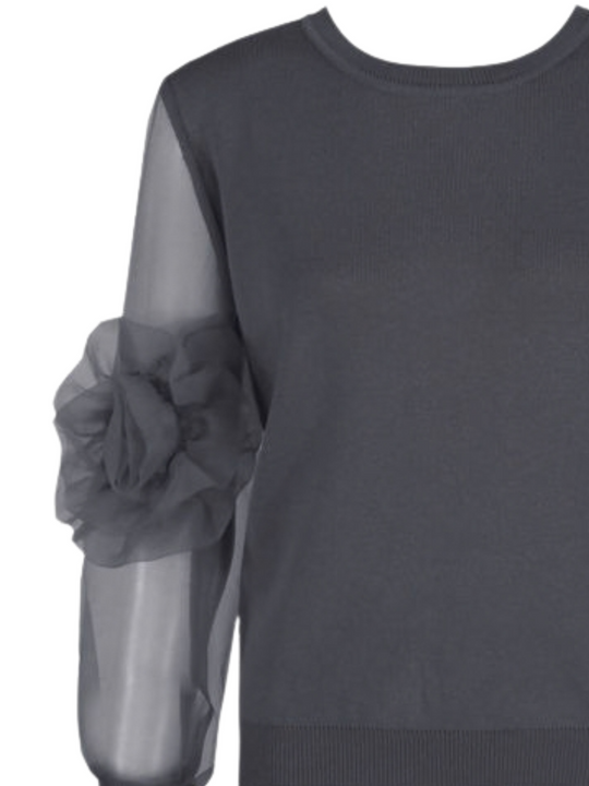 Close up. Ghost mannequin stands in front of a plain background and wears a grey crew neck jumper, with mesh sheered sleeves with a ruffled  sleeves balloon design, a signgle flowered ruffle design can be seen at the sleve.
