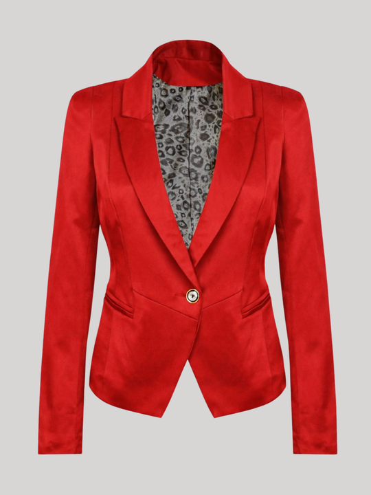 Ghost mannequin stands in front of a plain background. The ghost mannequin wears a red satin blazer, with single button fastening, with long sleeves, v neckline, front faux side pockets and red  satin lapel. The ghost mannequin faces forward, the front button fastening can be seen, including animal print internal lining can be seen.