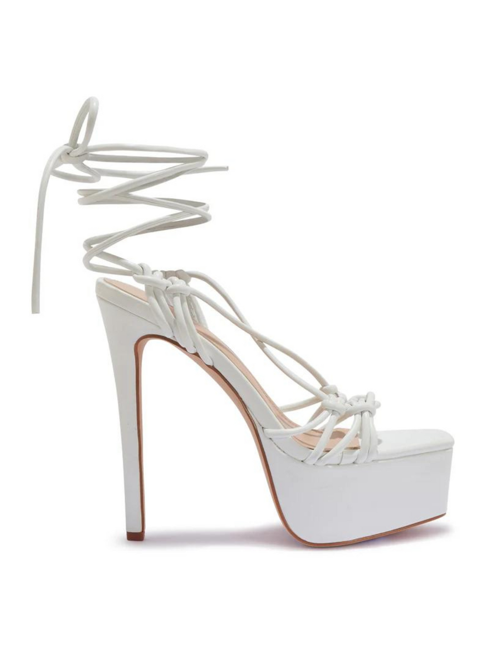 White shoes with a thick platform base and stiletto heel. The shoe has a strappy thigh lace up design. The side of the shoe can be seen, demonstrating the platform base and high stiletto heel.